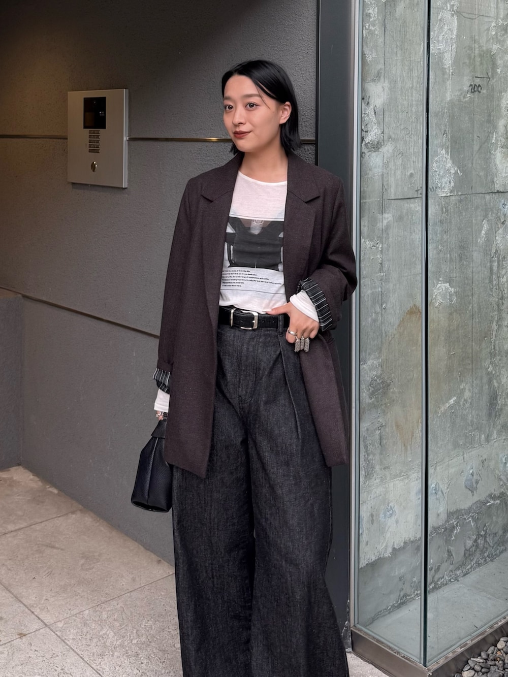 ブラウン系のテーラードジャケット、ホワイト系のTシャツ/カットソー、ブラック系のデニムパンツを着用したレディースの秋コーディネートの3枚目の写真