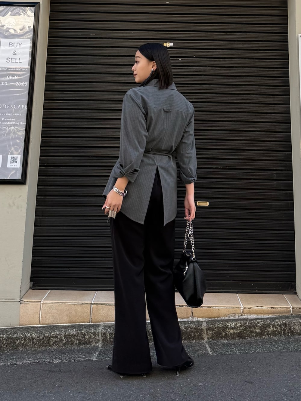 グレー系のシャツ/ブラウス、ブラック系のスラックス、ブラック系のトートバッグを着用したレディースの冬コーディネートの2枚目の写真