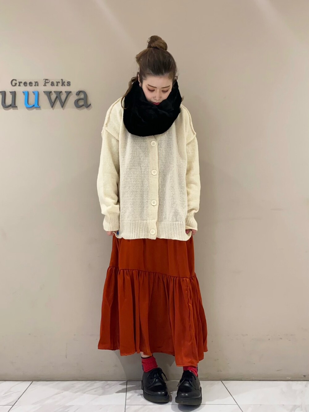 ホワイト系のカーディガン/ボレロ、レッド系のワンピース、ブラック系のネックウォーマー/スヌードを着用したレディースの冬コーディネートの2枚目の写真