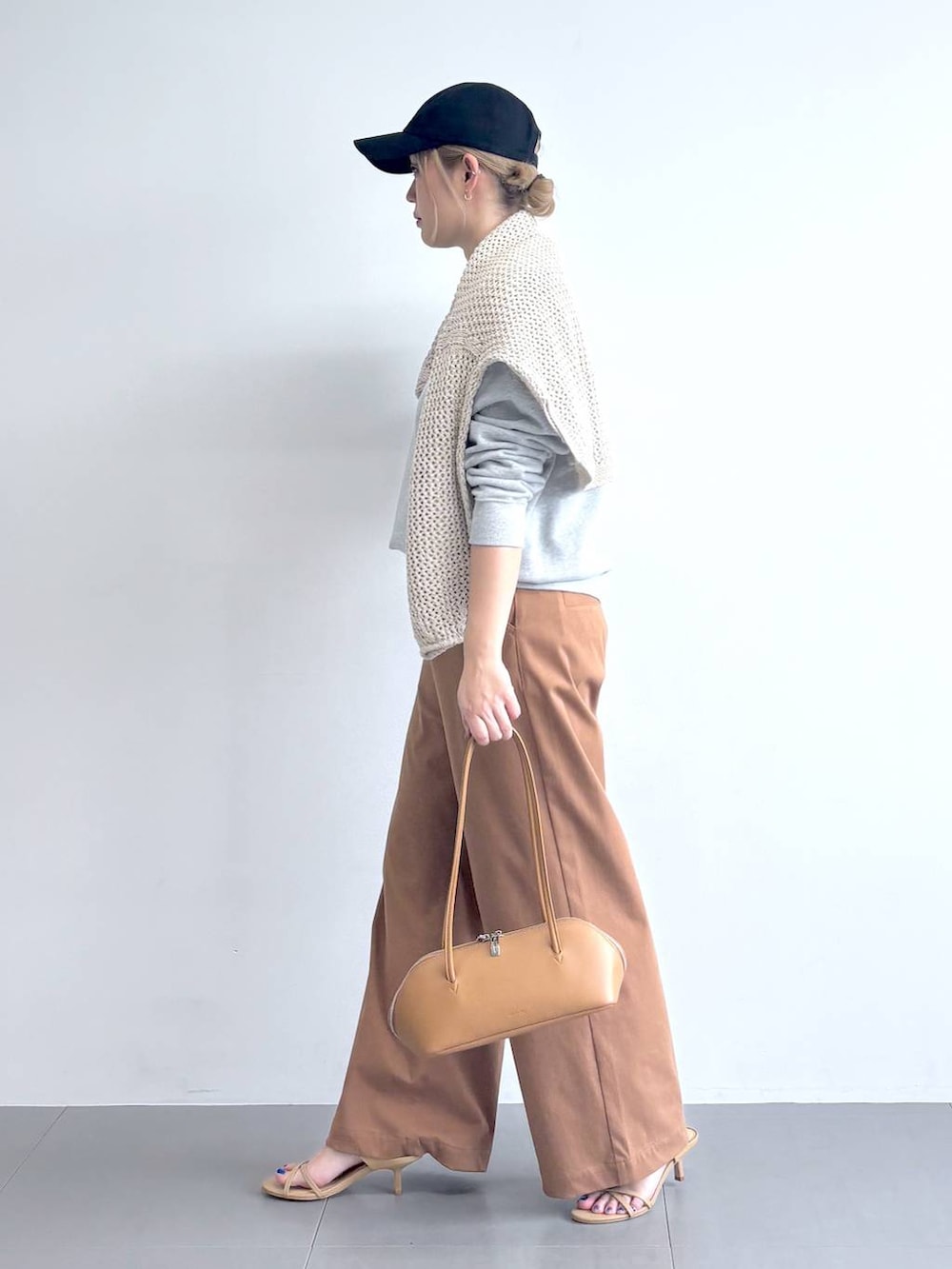 ベージュ系のニット/セーター、グレー系のスウェット、イエロー系のその他パンツを着用したレディースの冬コーディネートの2枚目の写真