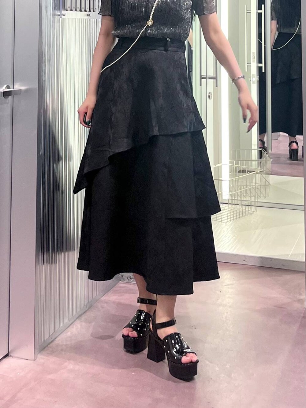 ブラック系のサンダル、ブラック系のスカート、ブラック系のTシャツ/カットソーを着用したレディースの春コーディネートの6枚目の写真