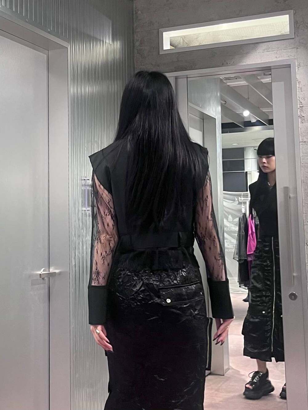 ブラック系のサンダル、ブラック系のテーラードジャケット、ブラック系のスカートを着用したレディースの夏コーディネートの6枚目の写真