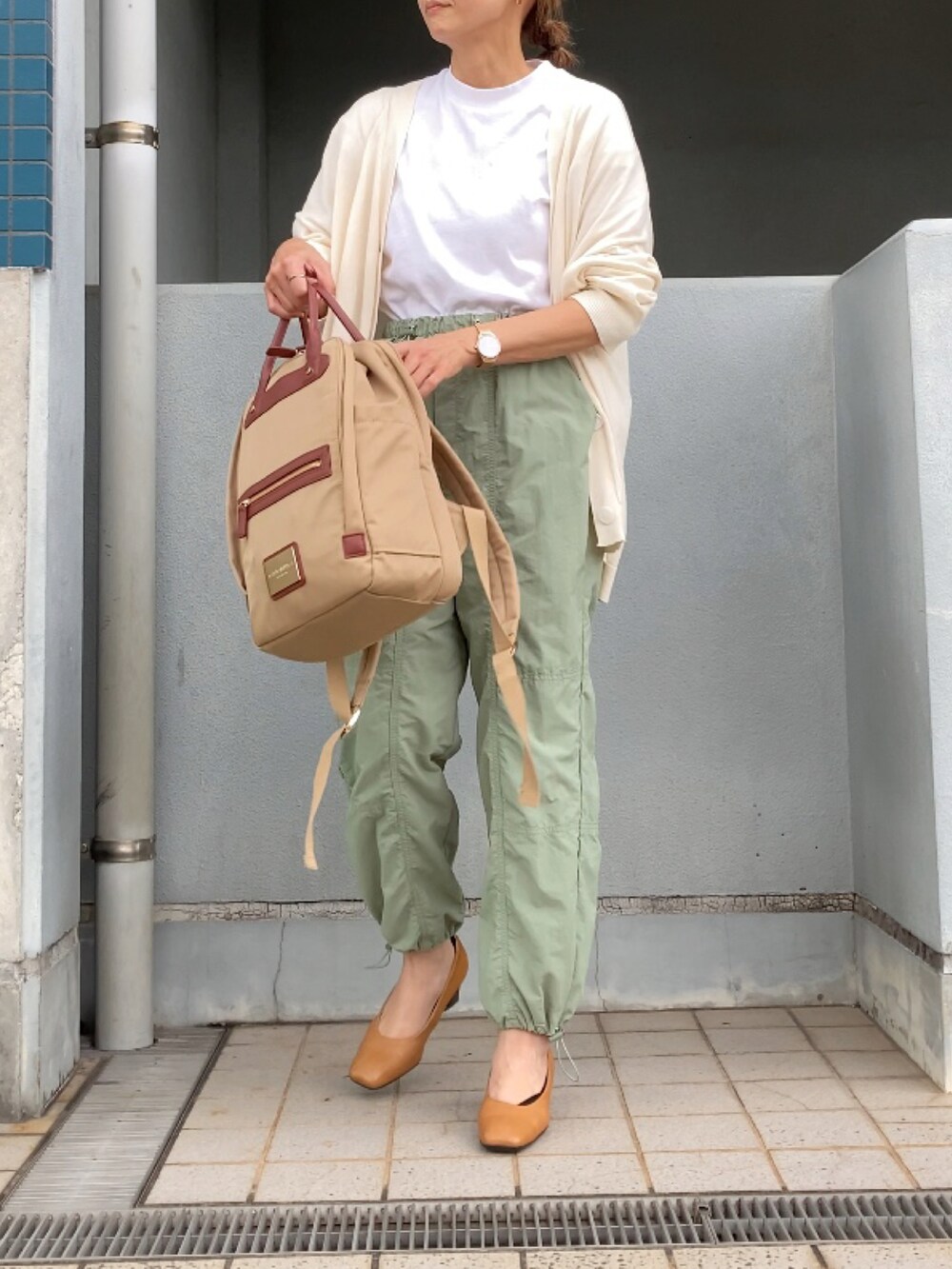 グリーン系のその他パンツ、ベージュ系のパンプス、ベージュ系のバックパック/リュックを着用したレディースの秋コーディネートの2枚目の写真