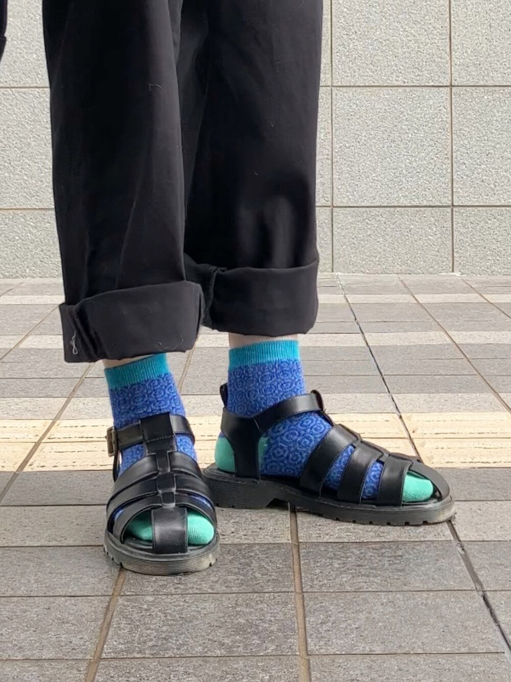 ブラック系のサロペット/オーバーオール、ホワイト系のニット/セーター、ブルー系のデニムジャケットを着用したレディースの春コーディネートの2枚目の写真