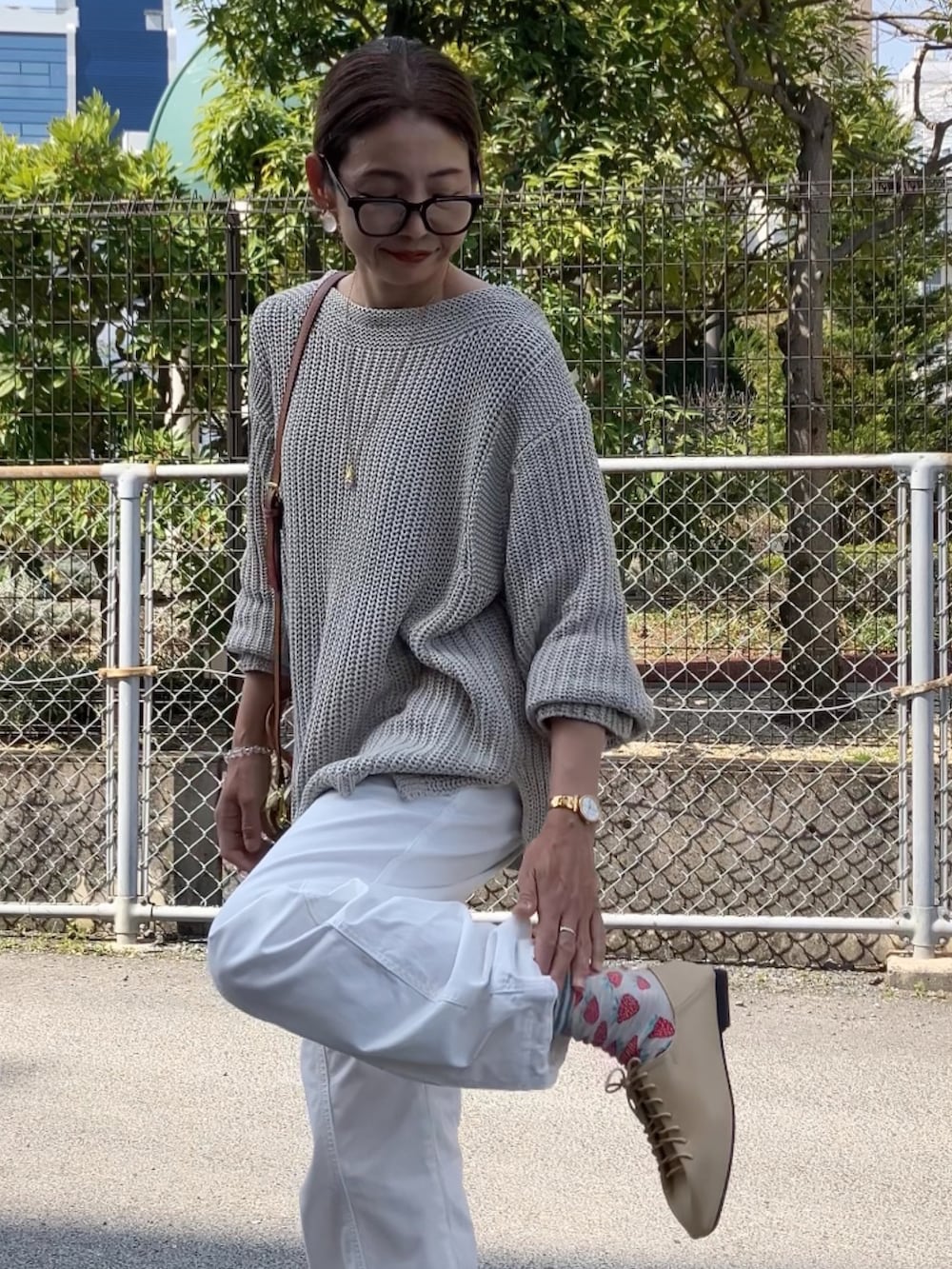 ベージュ系のその他シューズ、ベージュ系のニット/セーター、ベージュ系のボストンバッグを着用したレディースの春コーディネートの2枚目の写真