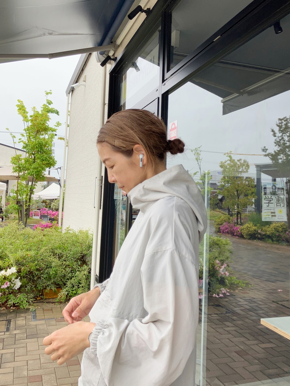 グレー系のブルゾン、ブラック系のその他パンツ、ホワイト系のスニーカーを着用したレディースの春コーディネートの2枚目の写真