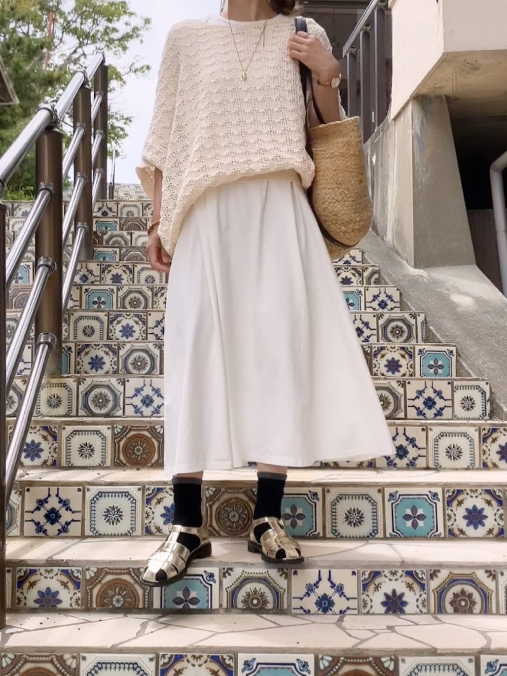 ゴールド系のサンダル、ベージュ系のニット/セーター、ベージュ系のバッグを着用したレディースの夏コーディネートの3枚目の写真