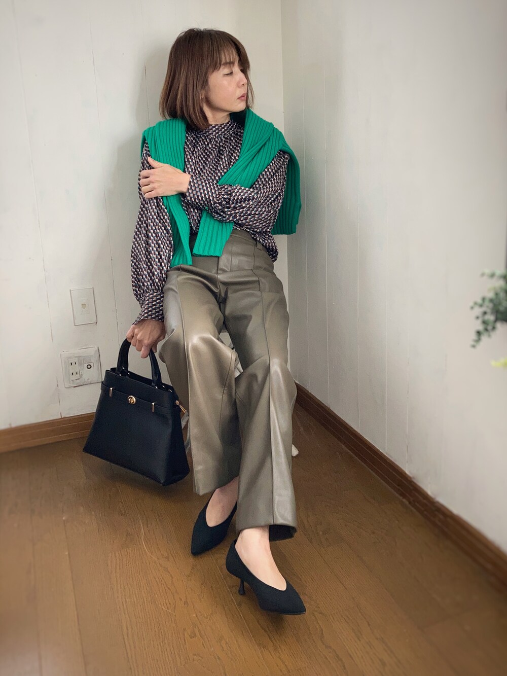 ブラウン系のパンツ、グリーン系のシャツ/ブラウス、グリーン系のニット/セーターを着用したレディースの冬コーディネートの2枚目の写真