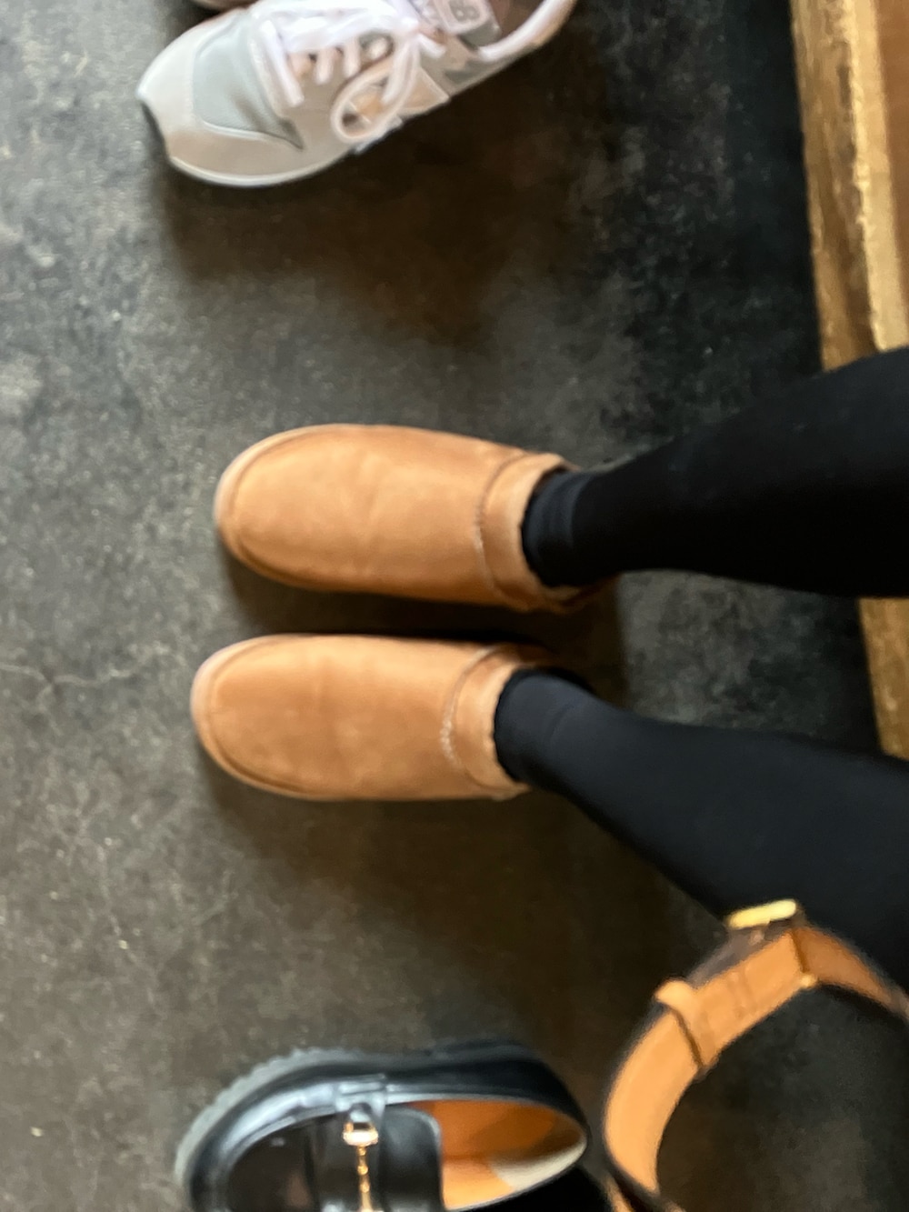 ホワイト系のTシャツ/カットソー、オレンジ系のカーディガン/ボレロ、ブラック系のその他アウターを着用したレディースの冬コーディネートの5枚目の写真