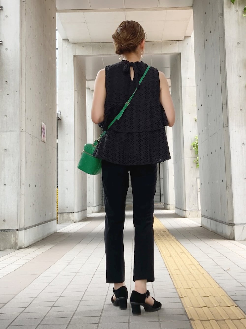 ブラック系のシャツ/ブラウス、ブラック系のパンツ、グリーン系のショルダーバッグを着用したレディースの夏コーディネートの2枚目の写真