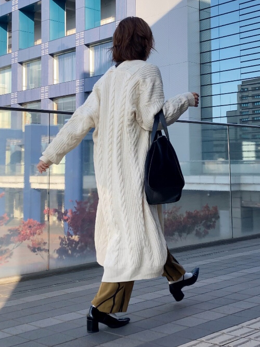 ベージュ系のカーディガン/ボレロ、ブラック系のニット/セーター、イエロー系のその他パンツを着用したレディースの秋コーディネートの3枚目の写真