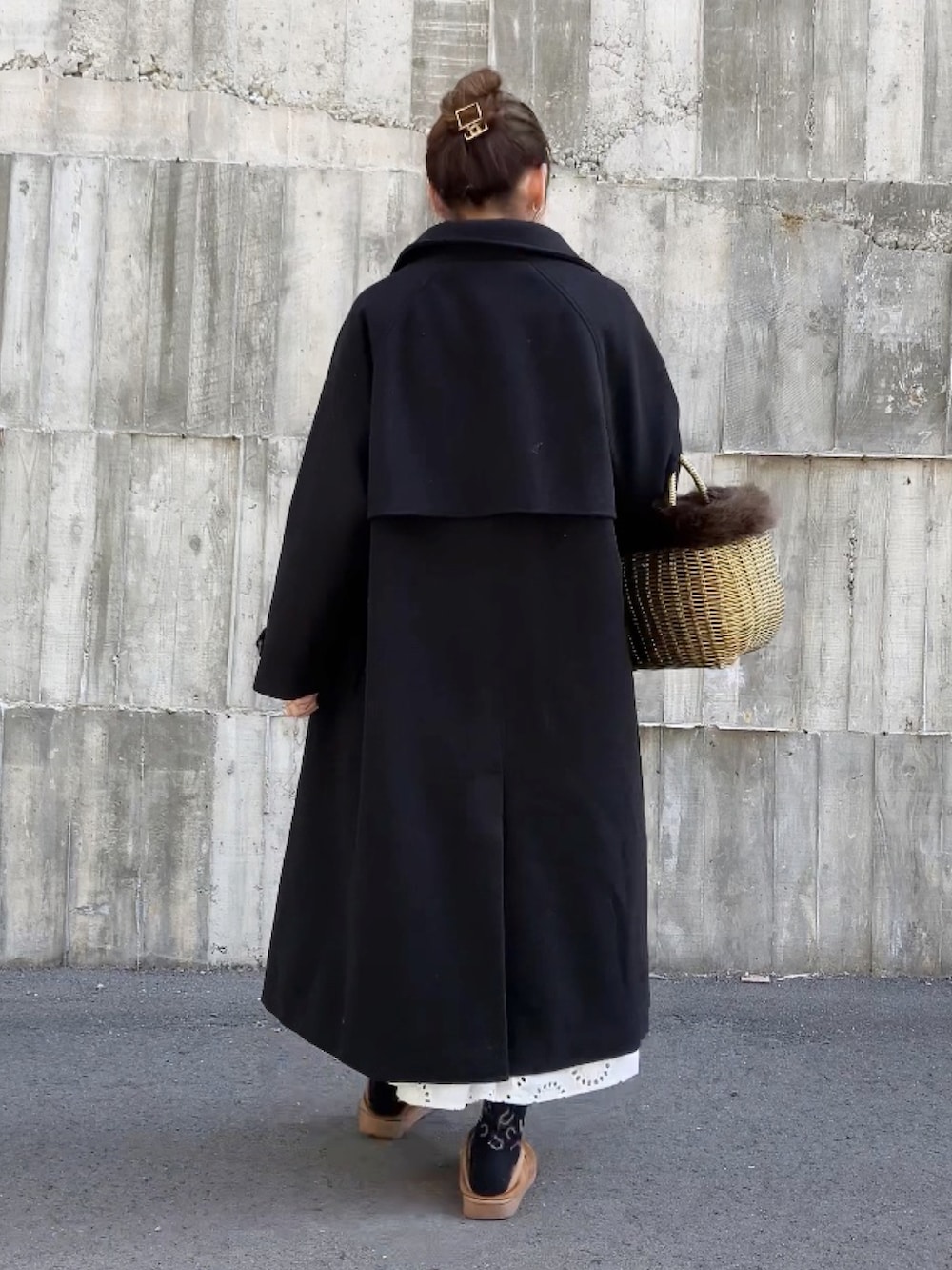 ゴールド系のかごバッグ、ホワイト系のワンピース/ドレス、ブラウン系のニット/セーターを着用したレディースの冬コーディネートの3枚目の写真