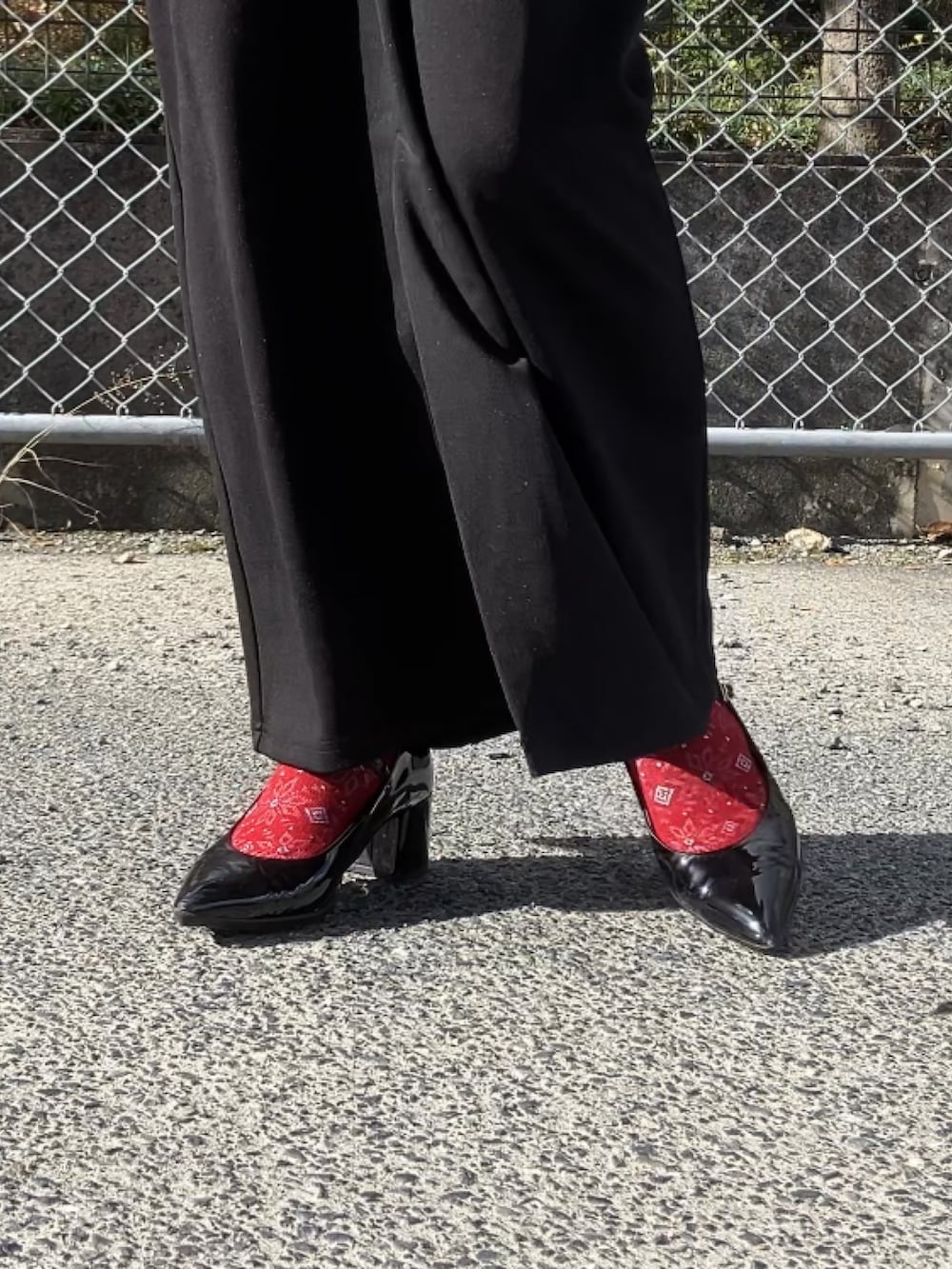 ブラック系のノーカラージャケット、ブラック系のジャンパースカート、ホワイト系のTシャツ/カットソーを着用したレディースの冬コーディネートの5枚目の写真