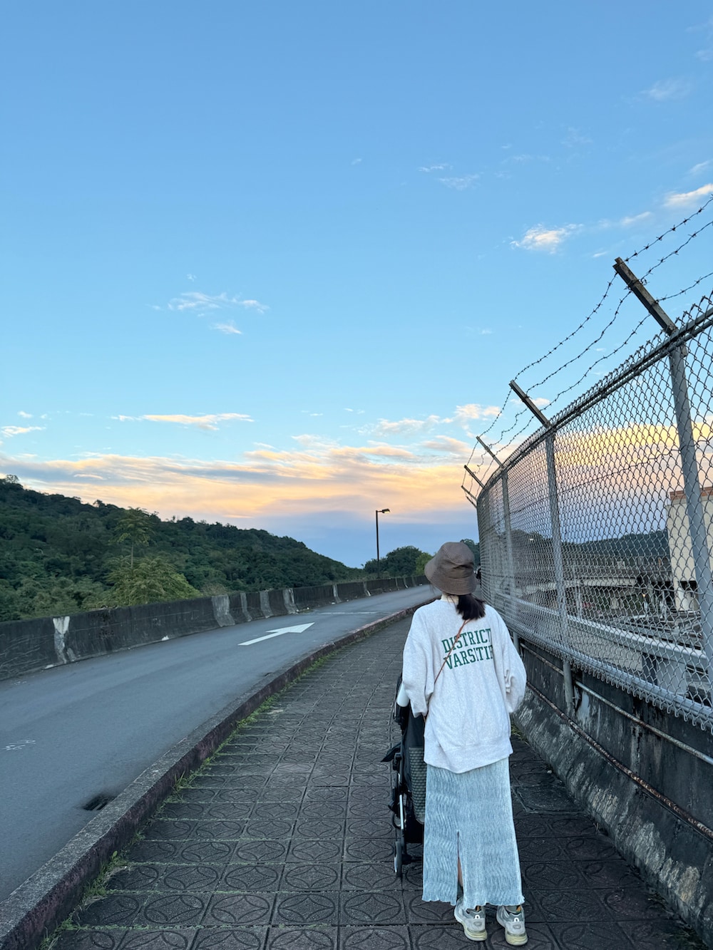 グレー系のスウェット、ブルー系のスカート、ブラウン系のハットを着用したレディースの冬コーディネートの2枚目の写真