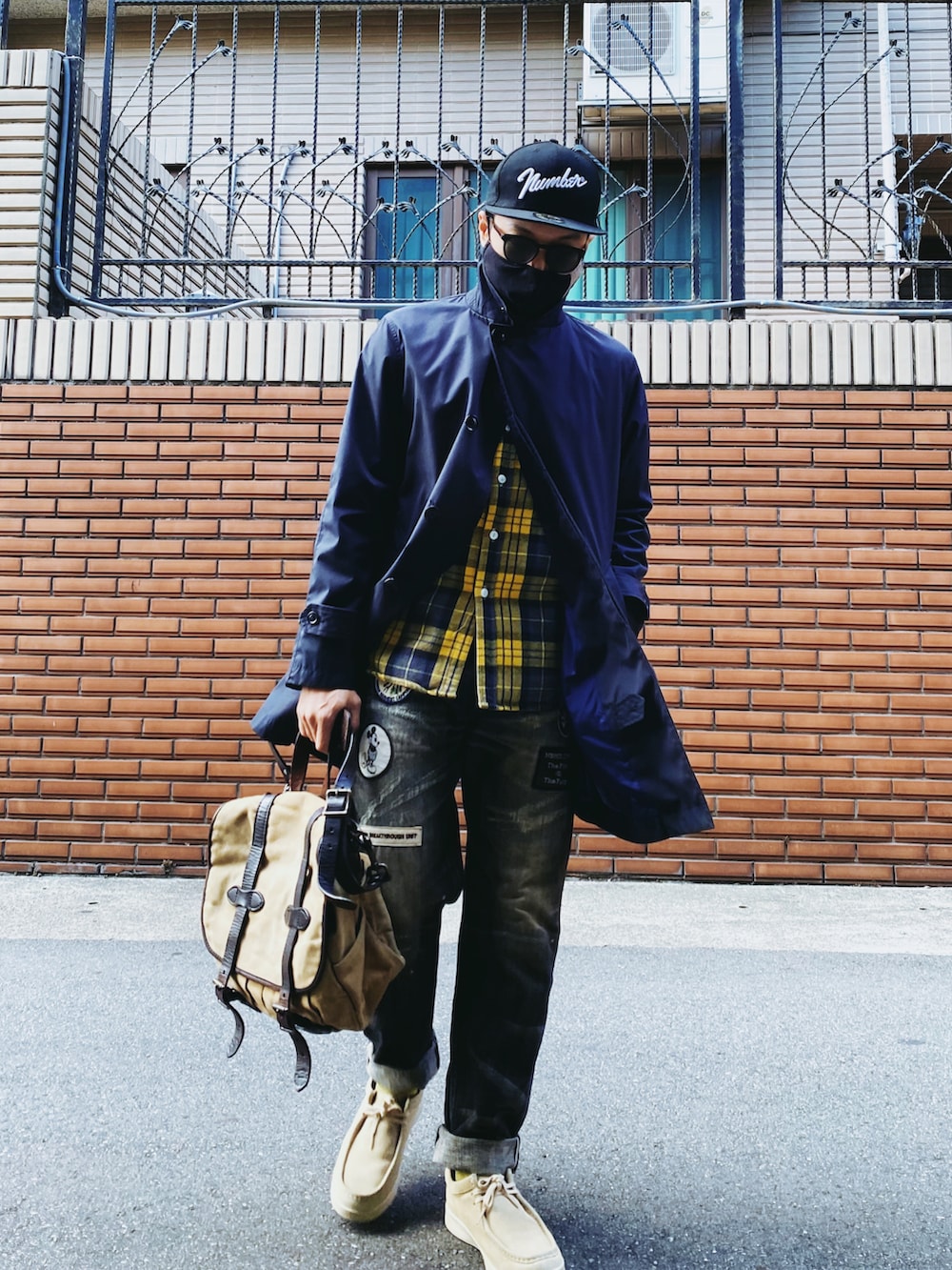 ブラック系のデニムパンツ、ベージュ系のその他シューズ、ブルー系のステンカラーコートを着用したメンズの秋コーディネートの3枚目の写真