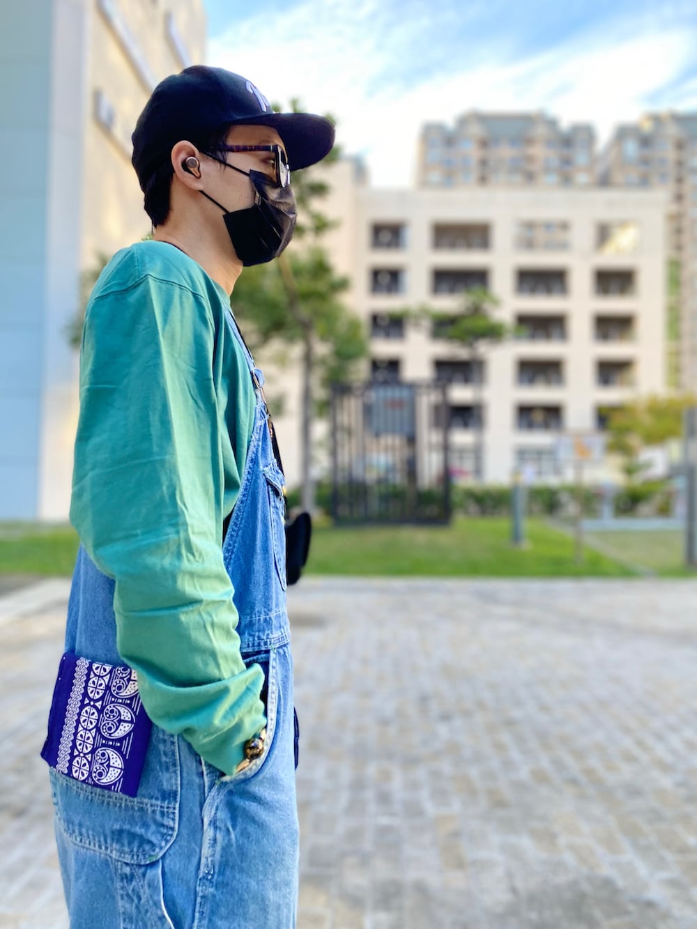 ブラウン系のブーツ、ブルー系のサロペット/オーバーオール、グリーン系のTシャツ/カットソーを着用したメンズの冬コーディネートの3枚目の写真