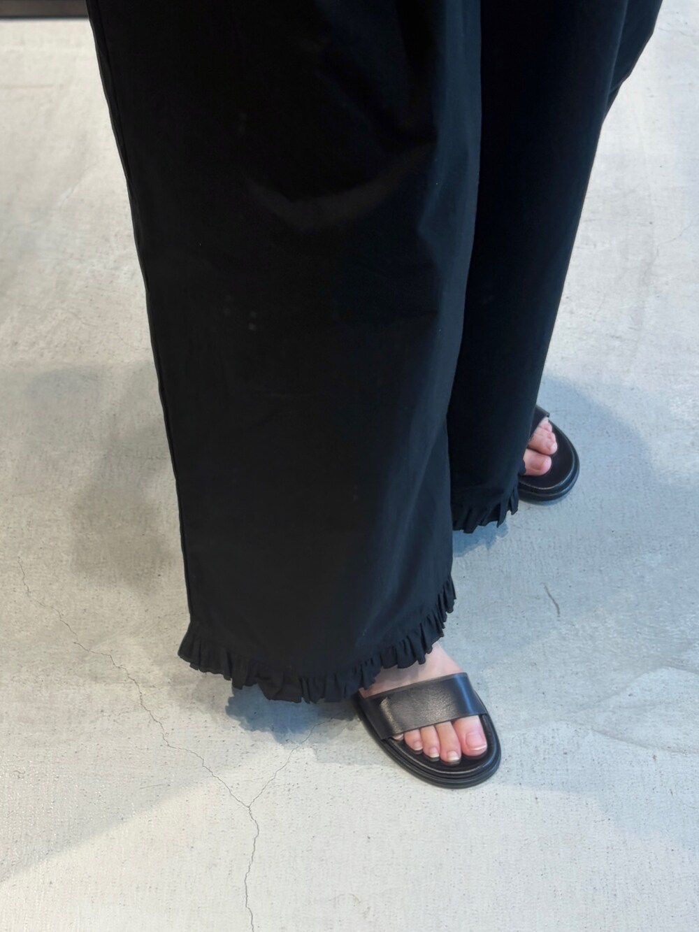ブルー系のベスト、イエロー系のハンドバッグ、ブラック系のその他パンツを着用したレディースの夏コーディネートの5枚目の写真