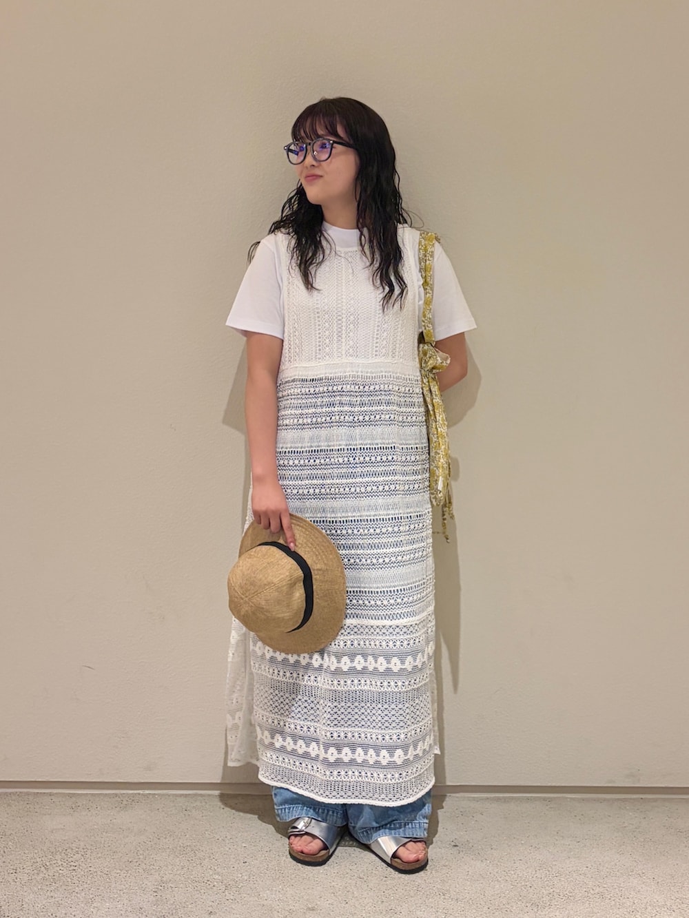 イエロー系のトートバッグ、ホワイト系のTシャツ/カットソー、ホワイト系のワンピースを着用したレディースの夏コーディネートの2枚目の写真