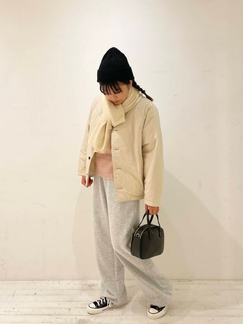 ブラック系のスニーカー、ブラック系のショルダーバッグ、ピンク系のニット/セーターを着用したレディースの秋コーディネートの5枚目の写真