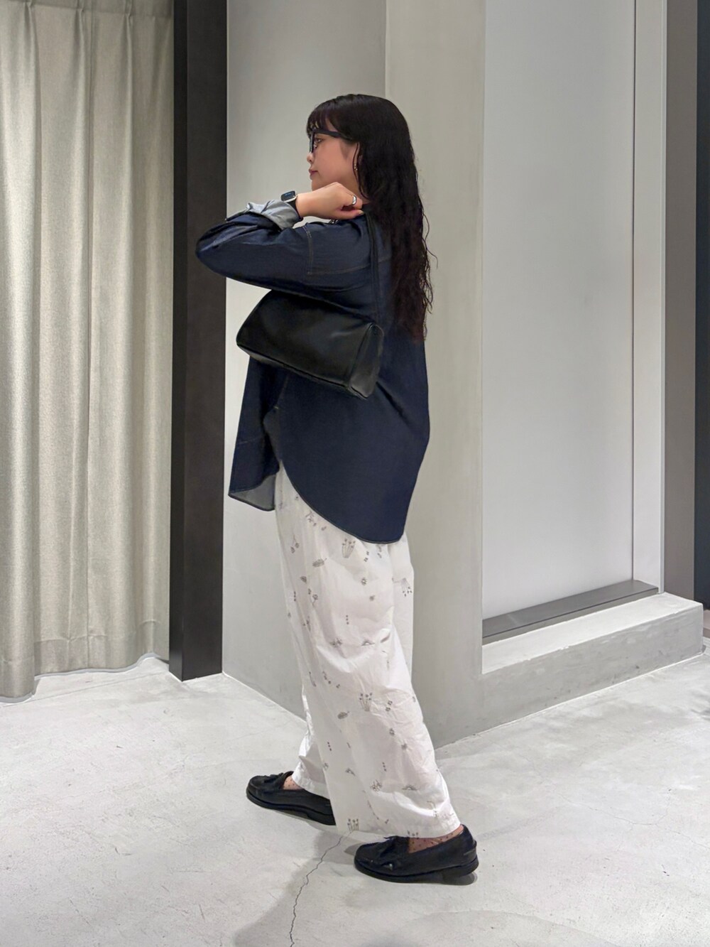 ブルー系のシャツ/ブラウス、ホワイト系のその他パンツ、ブラック系のハンドバッグを着用したレディースの夏コーディネートの3枚目の写真