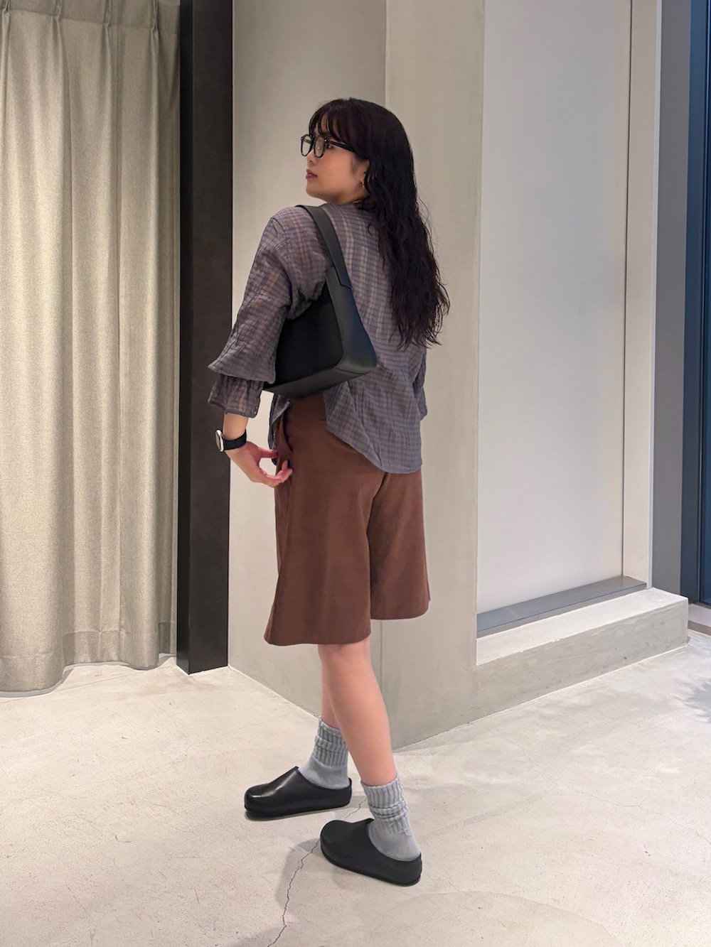 ブルー系のシャツ/ブラウス、ブラック系のハンドバッグ、ブラウン系のその他パンツを着用したレディースの夏コーディネートの3枚目の写真