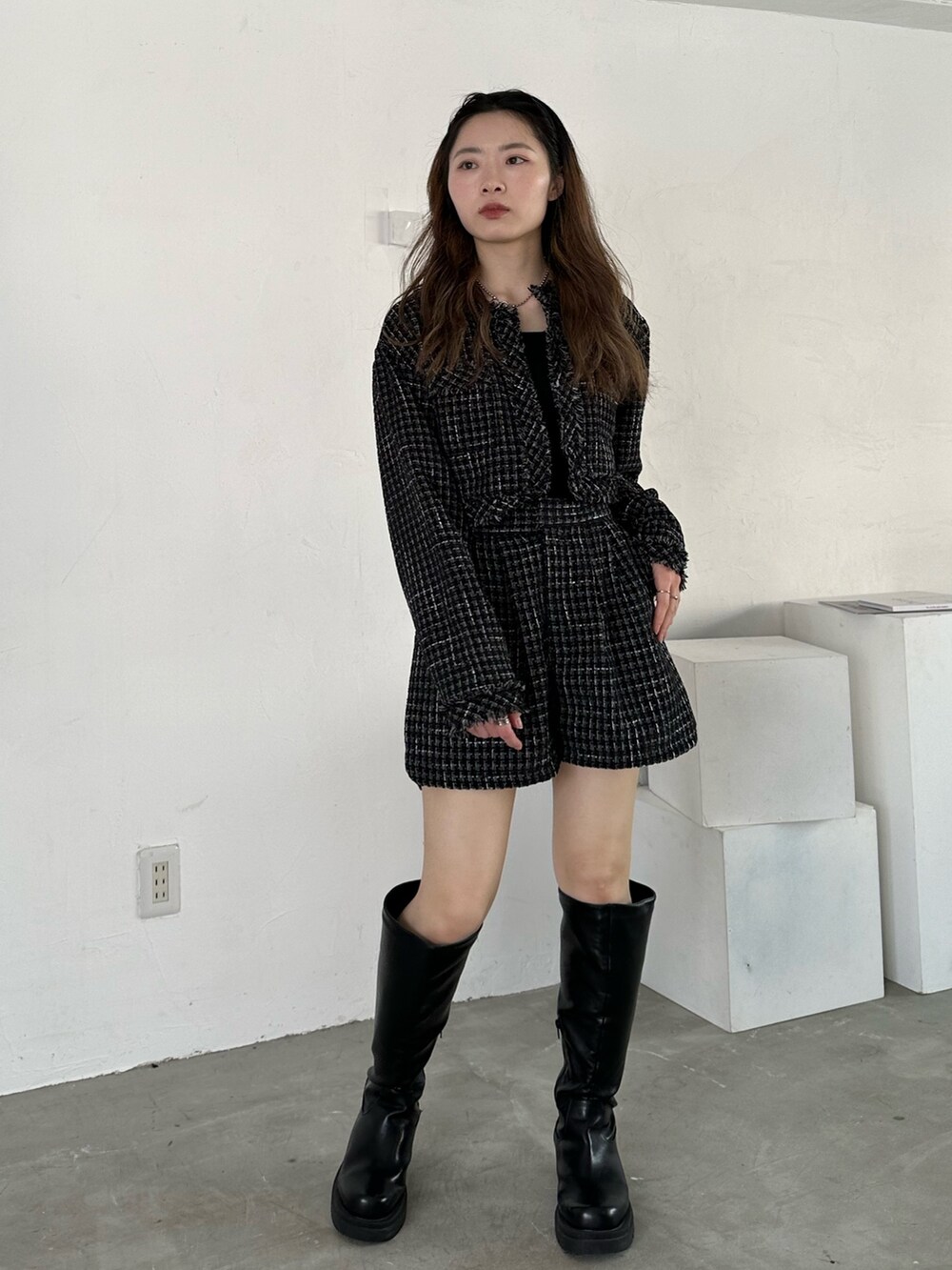 ブラック系のノーカラージャケット、ブラック系のその他パンツ、ブラック系のブーツを着用したレディースの冬コーディネートの3枚目の写真