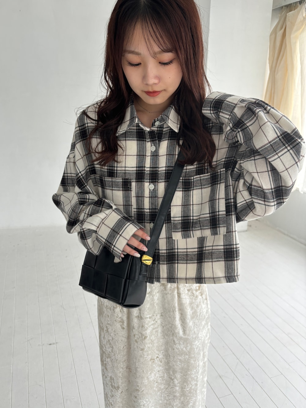 ホワイト系のシャツ/ブラウス、ベージュ系のスカート、ブラック系のブーツを着用したレディースの秋コーディネートの4枚目の写真