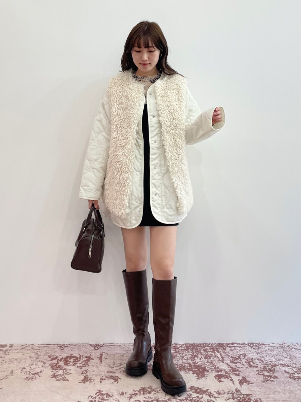 ブラック系のスニーカー、ホワイト系のベスト、ブラック系のTシャツ/カットソーを着用したレディースの夏コーディネートの4枚目の写真