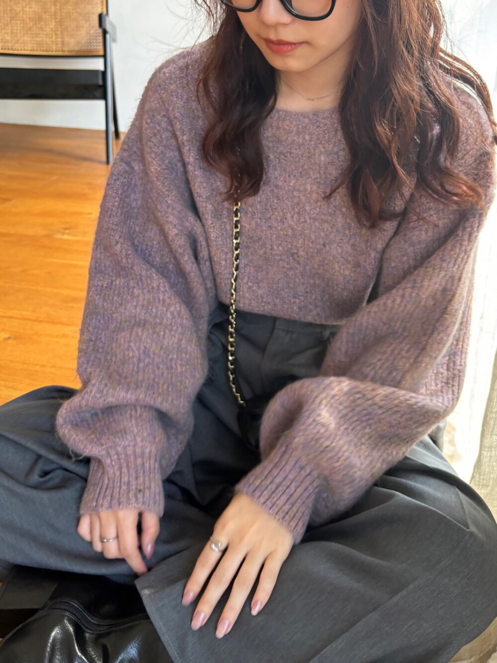 ピンク系のニット/セーター、グレー系のスラックス、ブラック系のブーツを着用したレディースの秋コーディネートの4枚目の写真