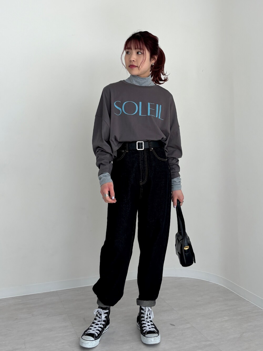 ブラック系のデニムパンツ、グレー系のTシャツ/カットソー、ベージュ系のトレンチコートを着用したレディースの春コーディネートの4枚目の写真