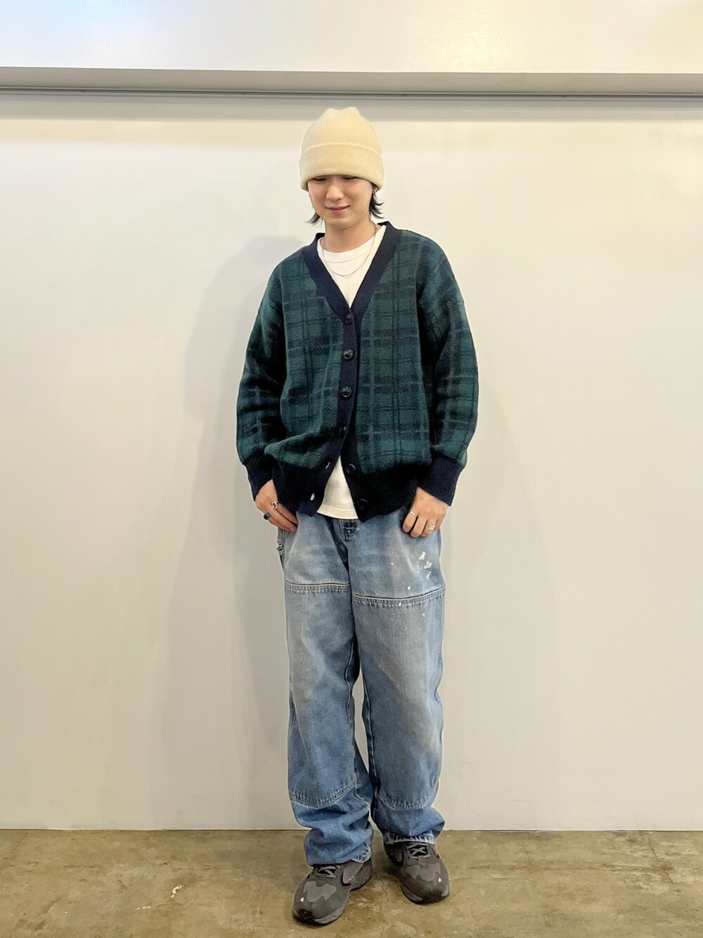 ブラック系のボストンバッグ、ベージュ系のブーツ、ブルー系のカーディガン/ボレロを着用したレディースの秋コーディネートの4枚目の写真