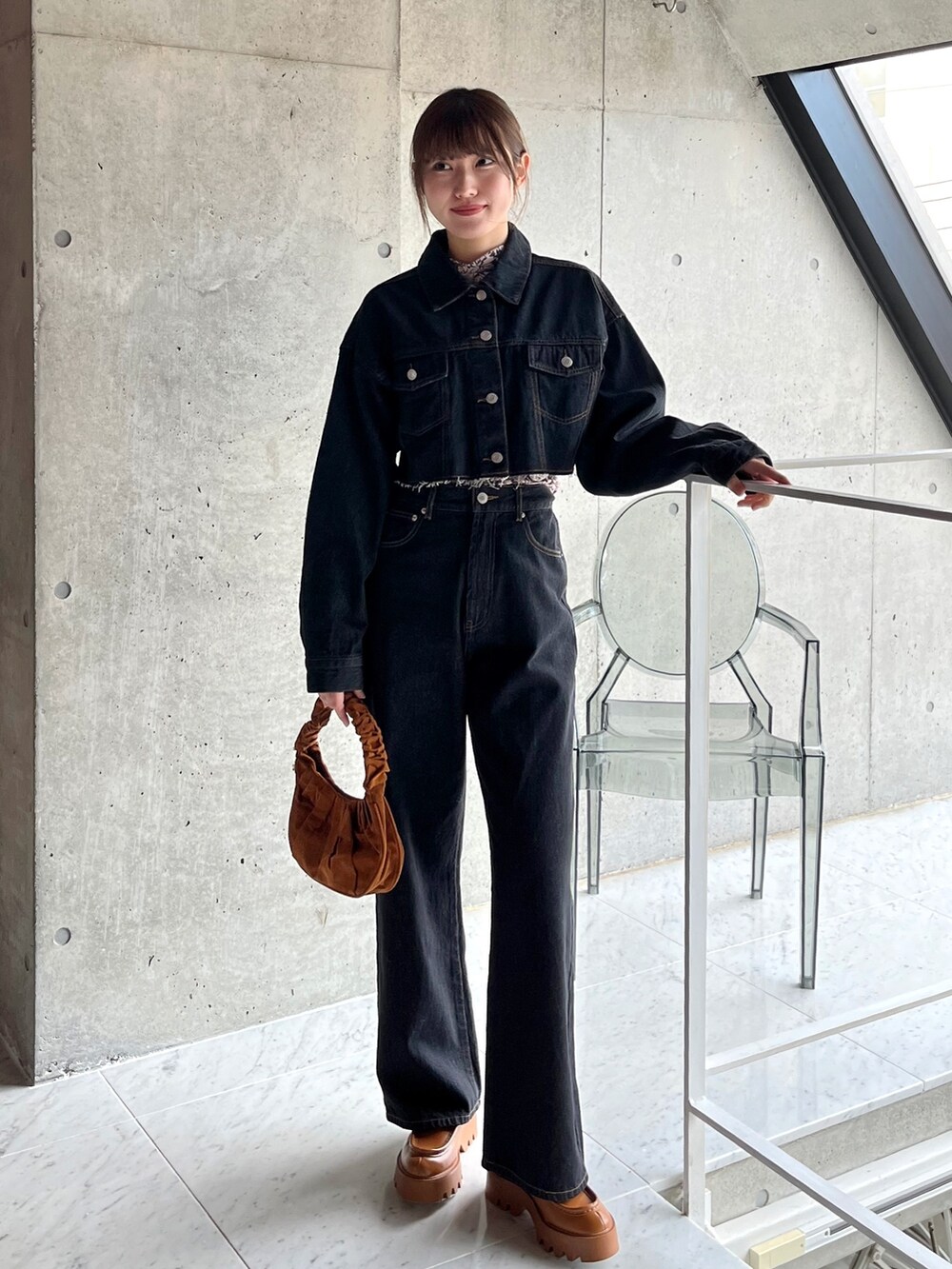 ブラック系のデニムパンツ、ブルー系のデニムジャケット、ベージュ系のTシャツ/カットソーを着用したレディースの春コーディネートの2枚目の写真