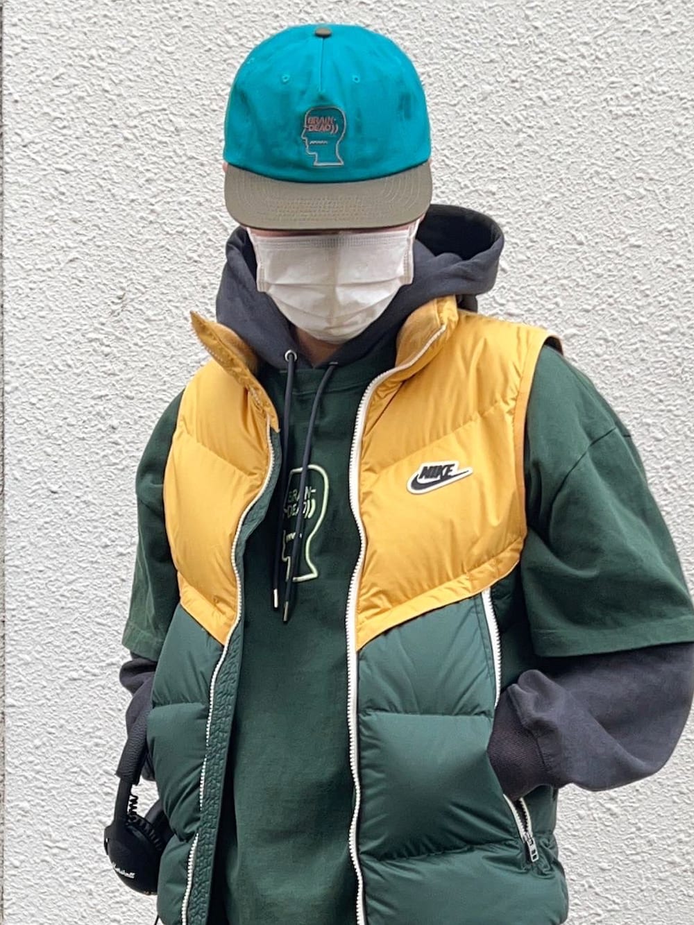 グリーン系のTシャツ/カットソー、イエロー系のダウンジャケット/コート、グリーン系のカーゴパンツを着用したメンズの冬コーディネートの2枚目の写真