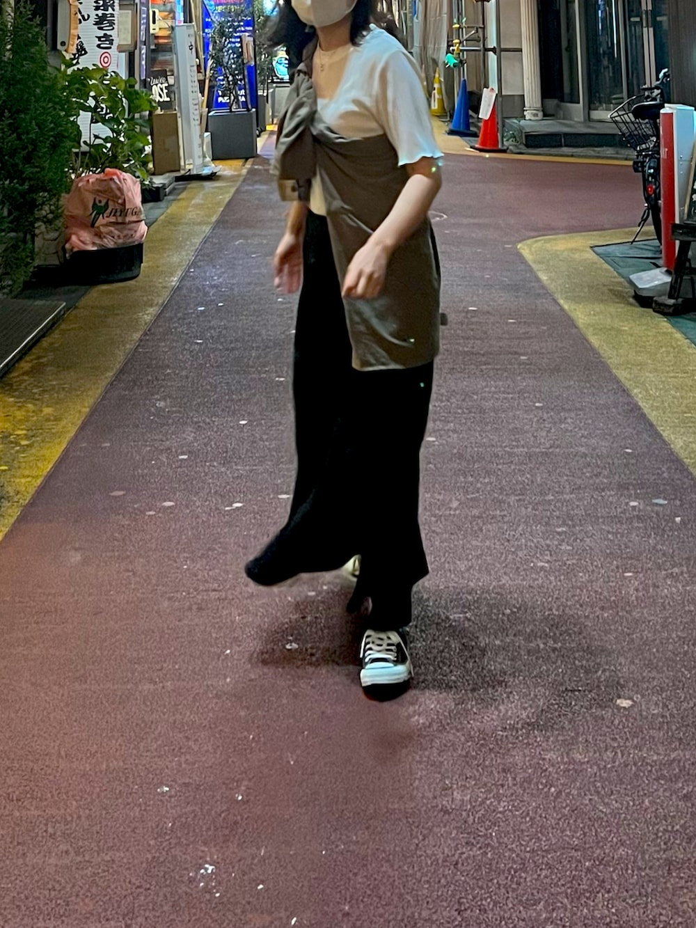 ブラック系のハンドバッグ、ホワイト系のTシャツ/カットソー、グリーン系のシャツ/ブラウスを着用したレディースの秋コーディネートの2枚目の写真