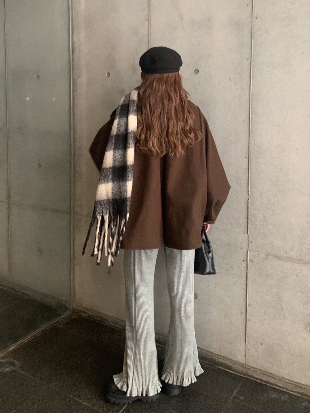 ブラック系のブーツ、グレー系のその他パンツ、ブラウン系のノーカラーコートを着用したレディースの冬コーディネートの3枚目の写真