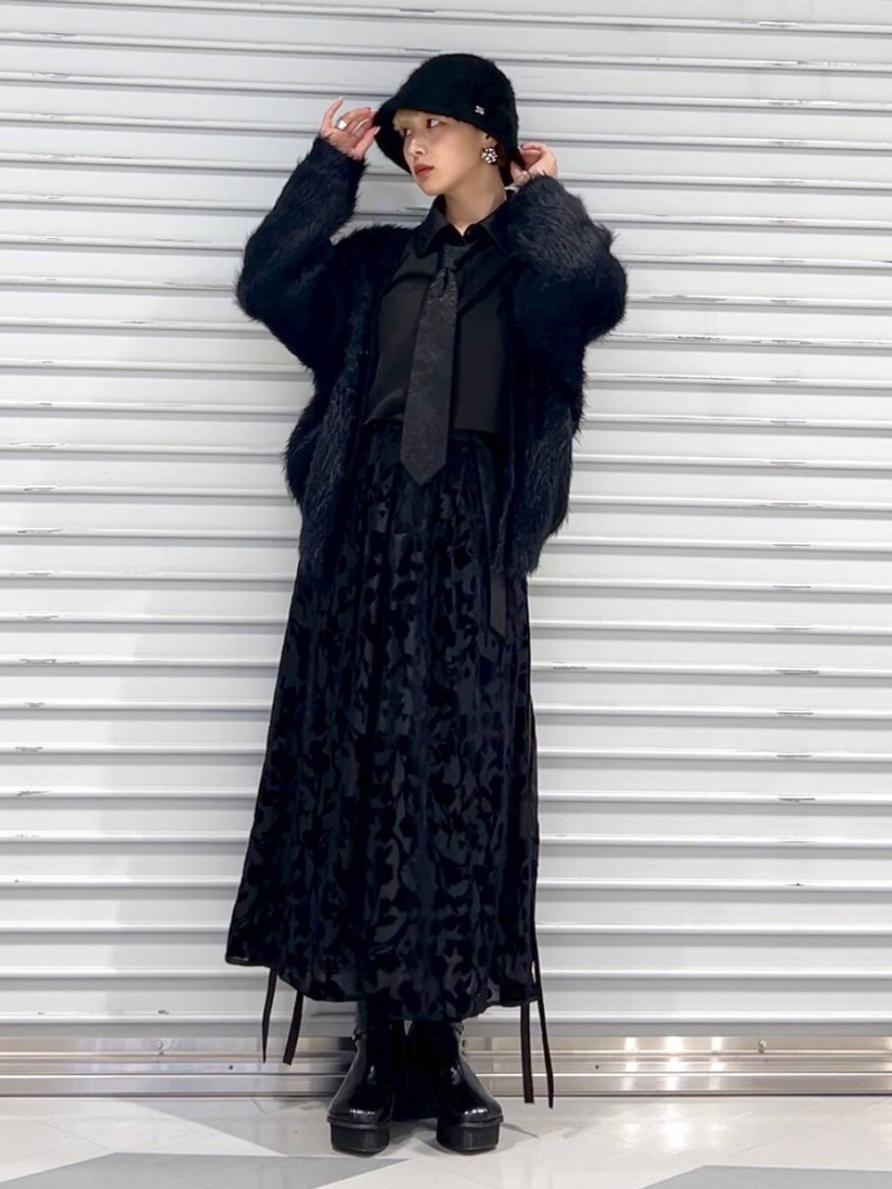 ブラック系のシャツ/ブラウス、ブラック系のカーディガン/ボレロ、ブラック系のブーツを着用したレディースの秋コーディネートの2枚目の写真