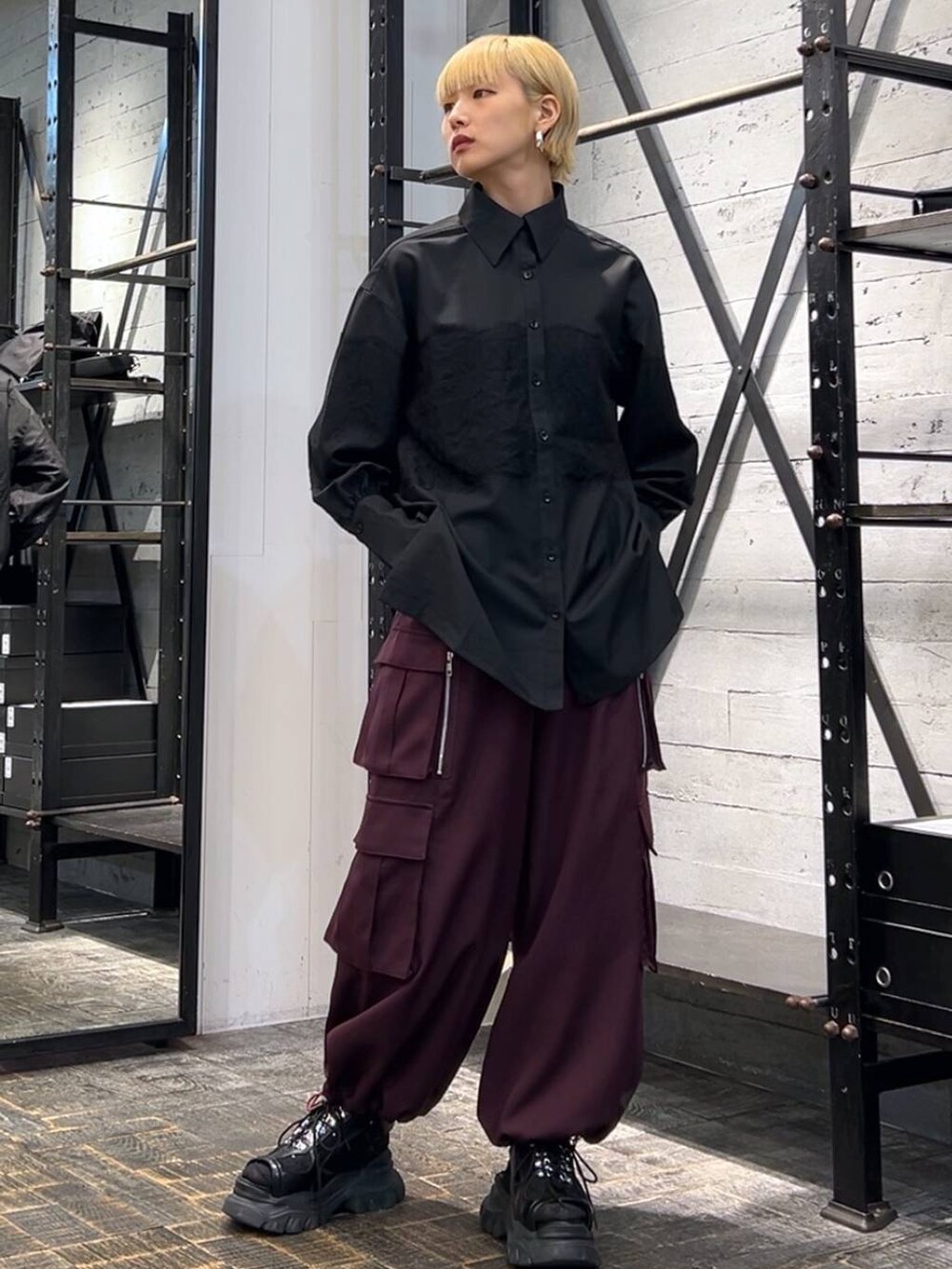 ブラック系のサンダル、レッド系のカーゴパンツ、ブラック系のシャツ/ブラウスを着用したレディースの秋コーディネートの2枚目の写真