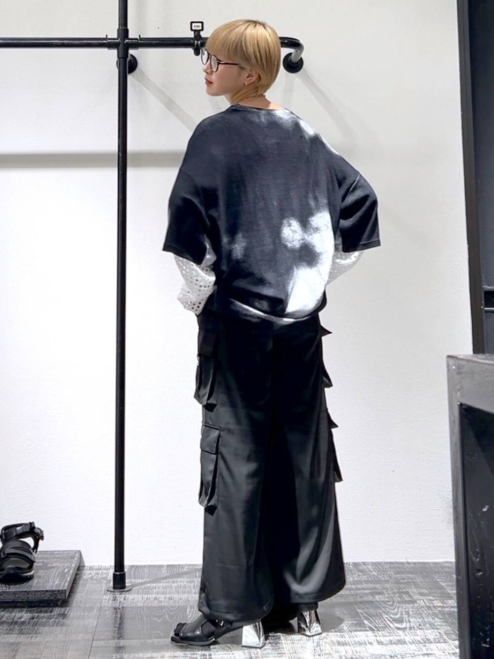 ブラック系のカーゴパンツ、ブラック系のサンダル、ホワイト系のTシャツ/カットソーを着用したレディースの春コーディネートの2枚目の写真