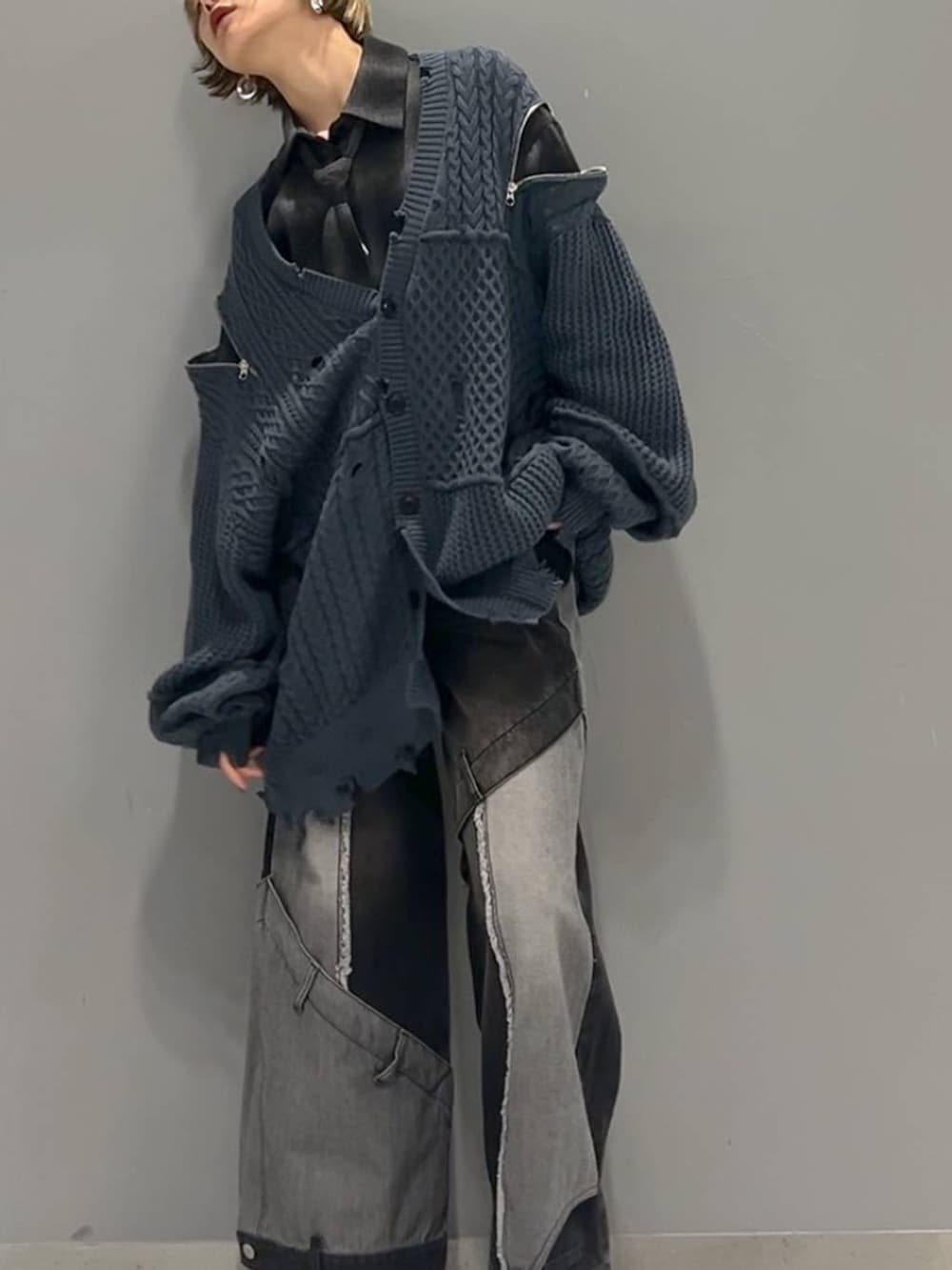 ブラック系のデニムパンツ、ブルー系のカーディガン/ボレロ、ブラック系のブーツを着用したレディースの秋コーディネートの3枚目の写真