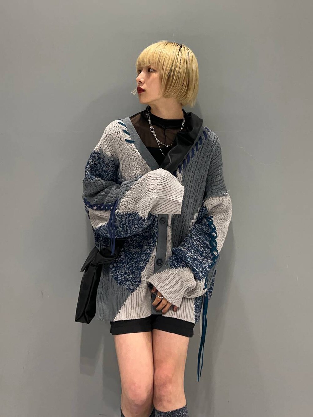 グレー系のカーディガン/ボレロ、ブラック系のショルダーバッグ、シルバー系のネックレスを着用したレディースの秋コーディネートの4枚目の写真