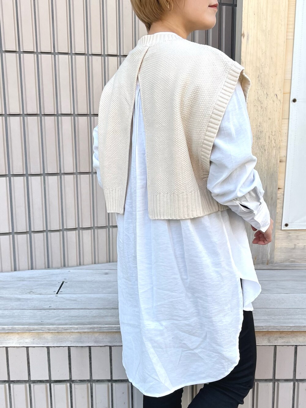 ホワイト系のシャツ/ブラウス、ホワイト系のベスト、ブラック系のデニムパンツを着用したレディースの冬コーディネートの2枚目の写真