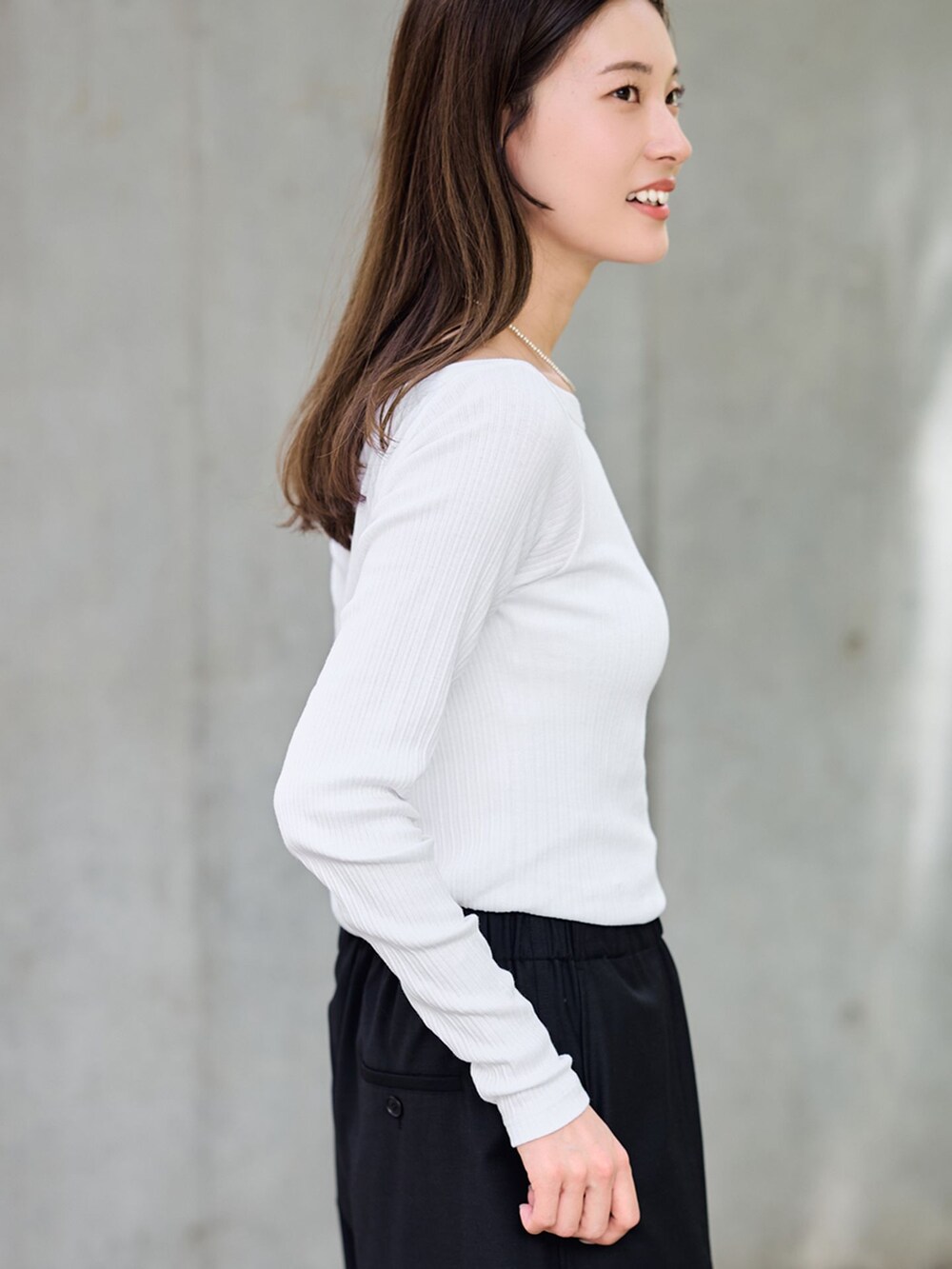 ブラック系のスラックス、ホワイト系のTシャツ/カットソー、ブラック系のショルダーバッグを着用したレディースの夏コーディネートの7枚目の写真