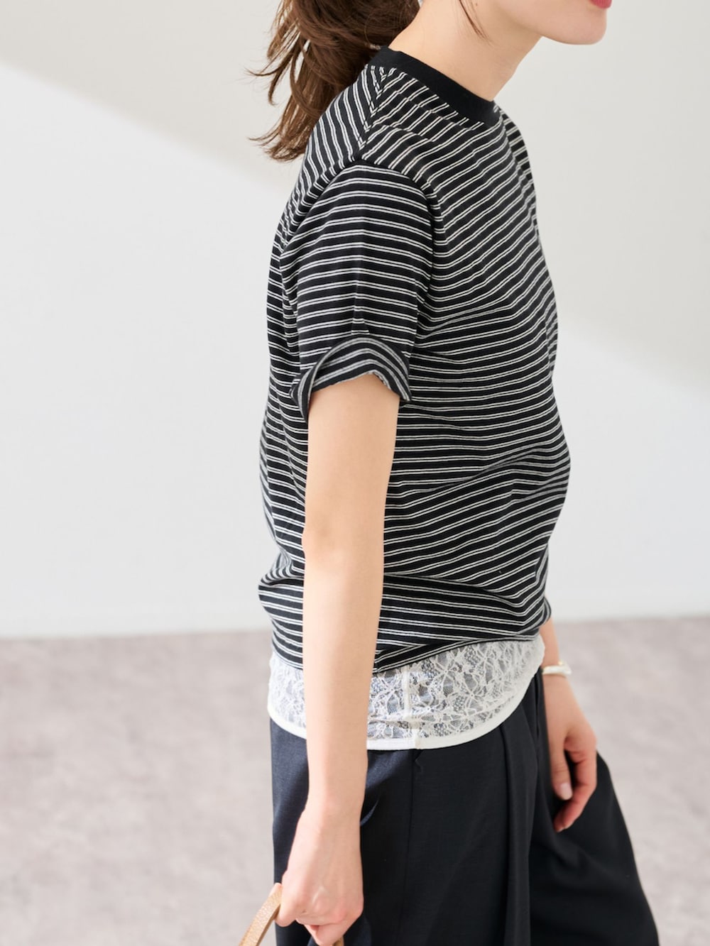 ブラック系のスラックス、ブラック系のTシャツ/カットソーを着用したレディースの春コーディネートの5枚目の写真