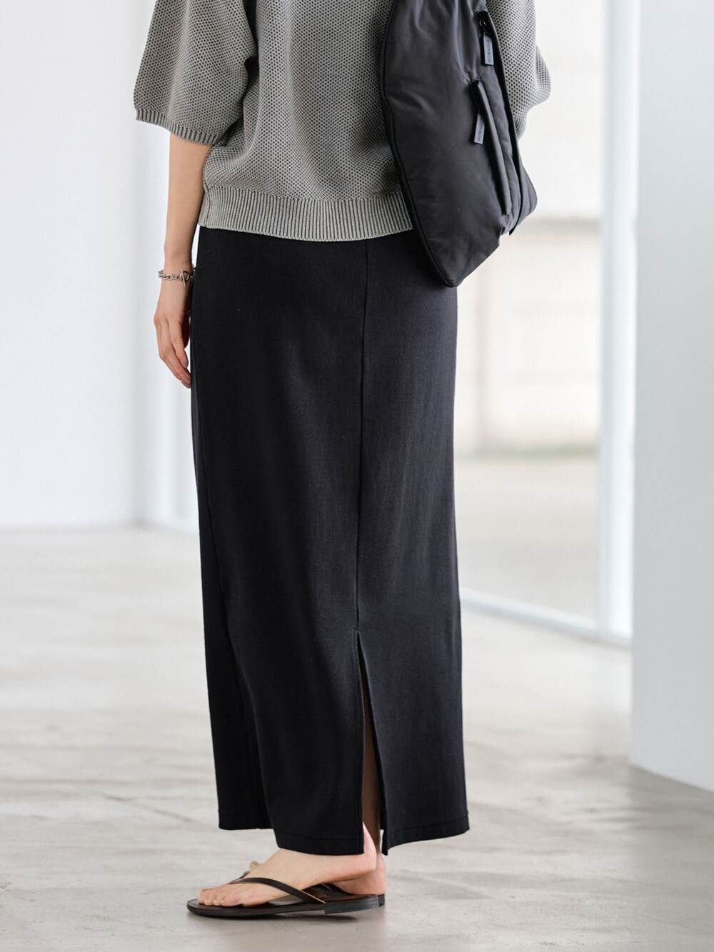 ブラック系のスカート、グリーン系のニット/セーターを着用したレディースの冬コーディネートの6枚目の写真