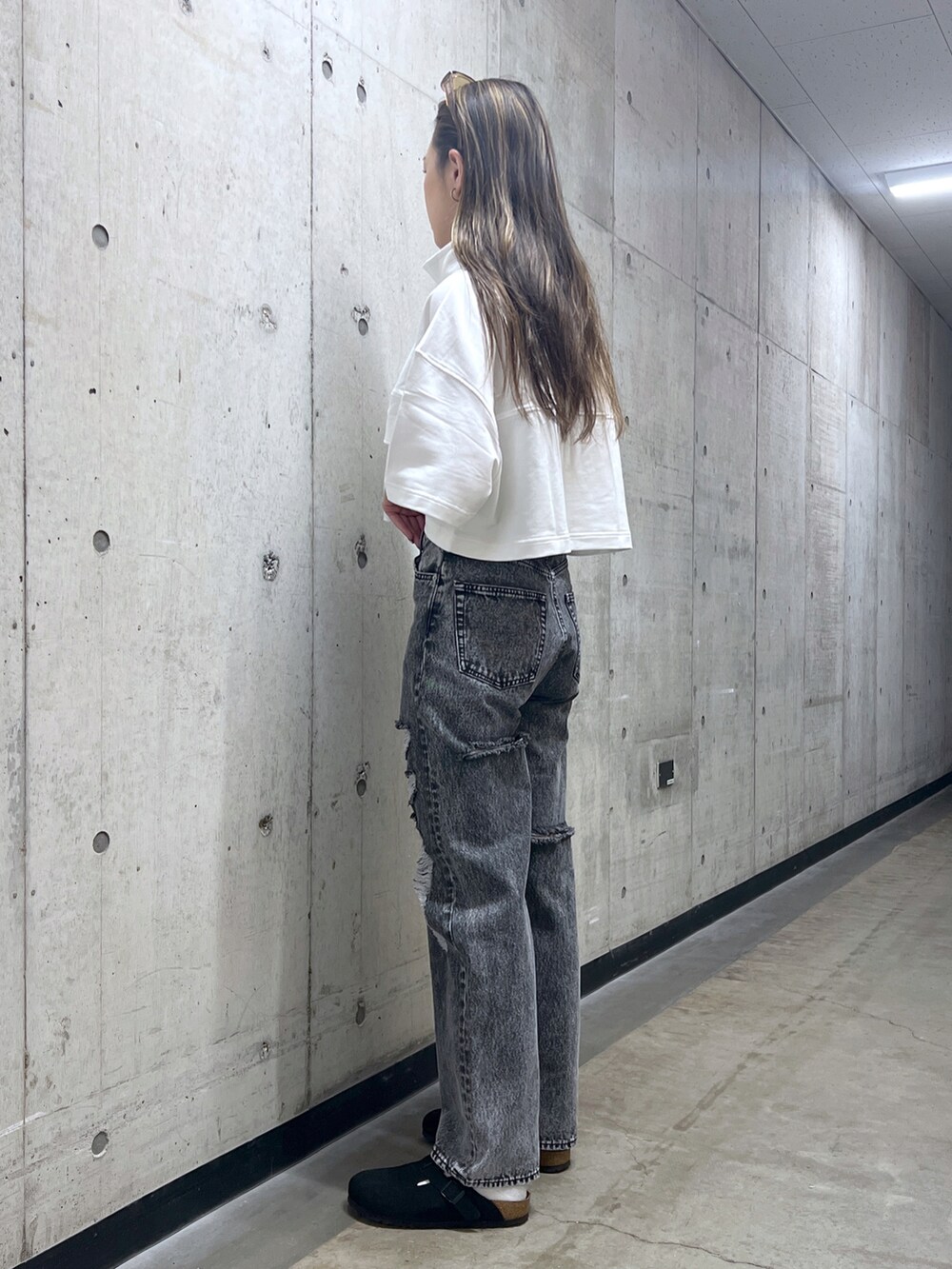 ブラック系のデニムパンツ、ホワイト系のTシャツ/カットソーを着用したレディースの春コーディネートの2枚目の写真