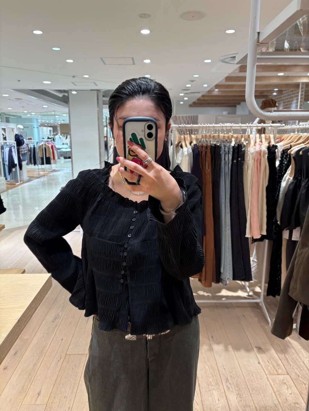 ブラック系のシャツ/ブラウス、ブラウン系のデニムパンツを着用したレディースの秋コーディネートの2枚目の写真