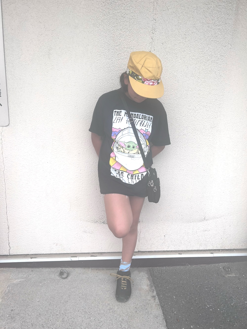 ブラック系のTシャツ/カットソー、ブルー系のデニムパンツ、ブラック系のスニーカーを着用したレディースの夏コーディネートの2枚目の写真