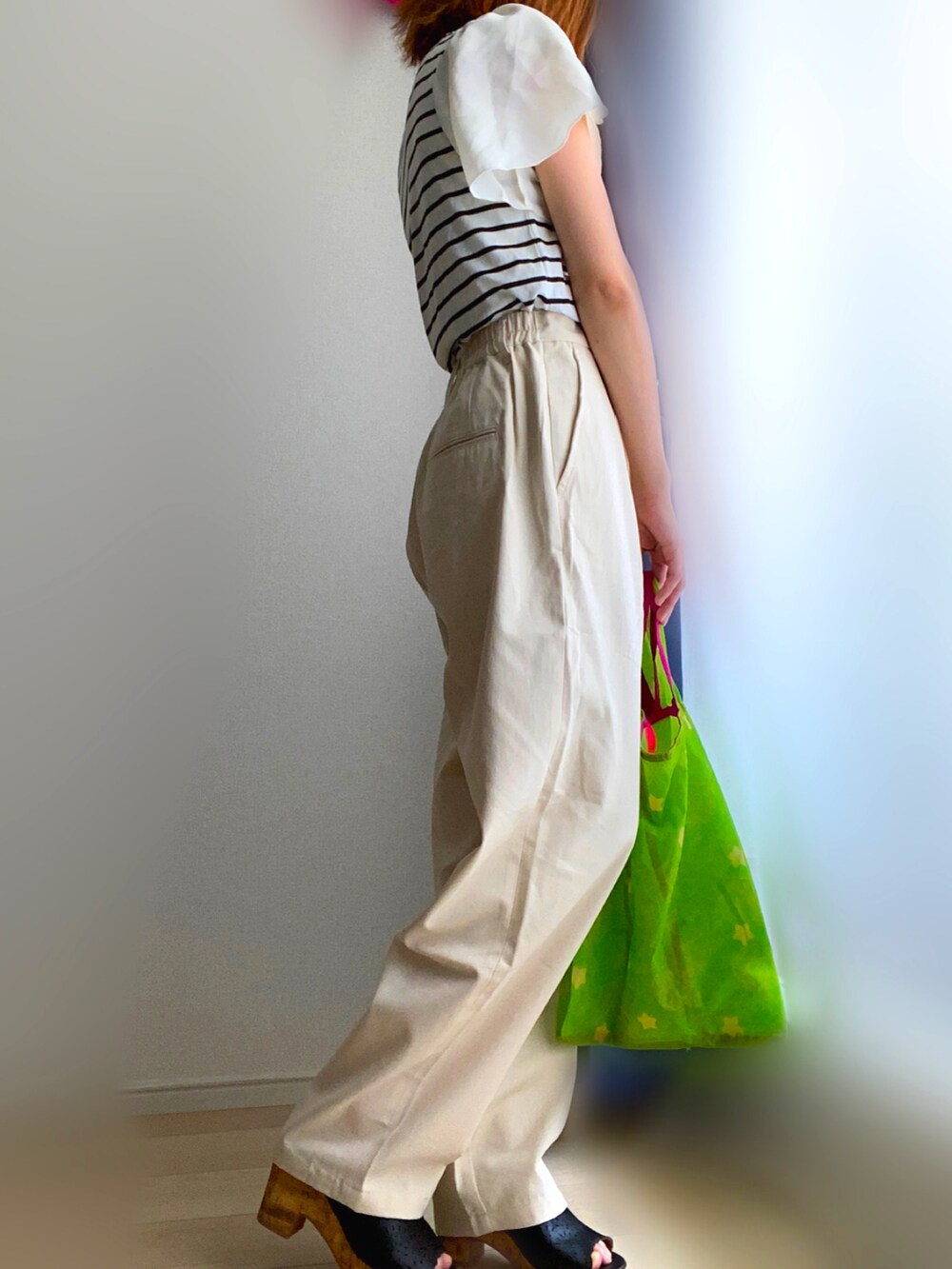 ホワイト系のTシャツ/カットソー、ベージュ系のチノパンツ、グリーン系のエコバッグ/サブバッグを着用したレディースの夏コーディネートの2枚目の写真