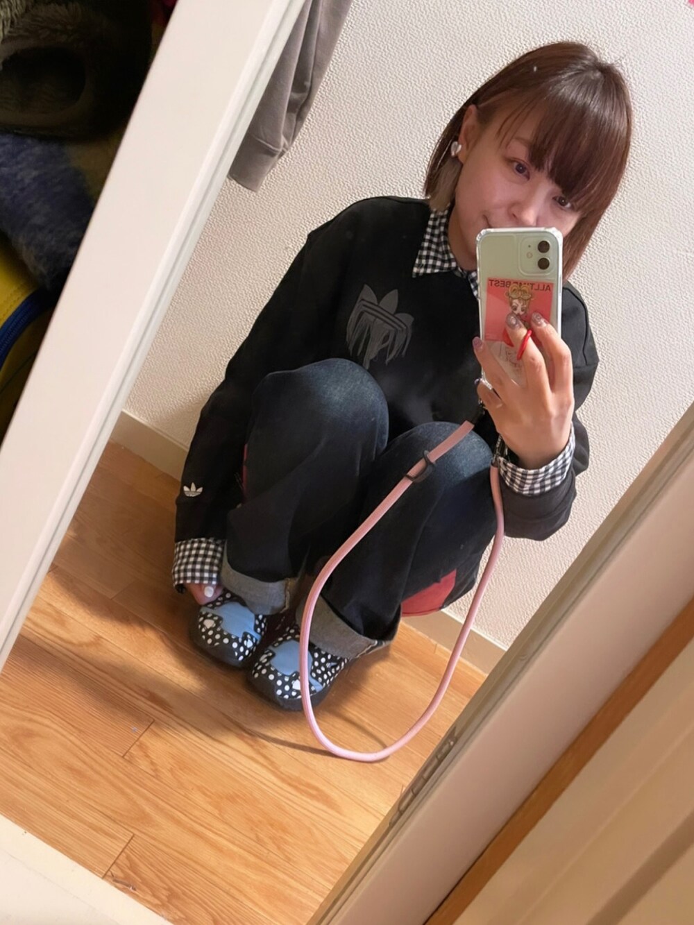 ブラック系のスウェット、ブラック系のデニムパンツ、ブラック系のスニーカーを着用したレディースの冬コーディネートの3枚目の写真