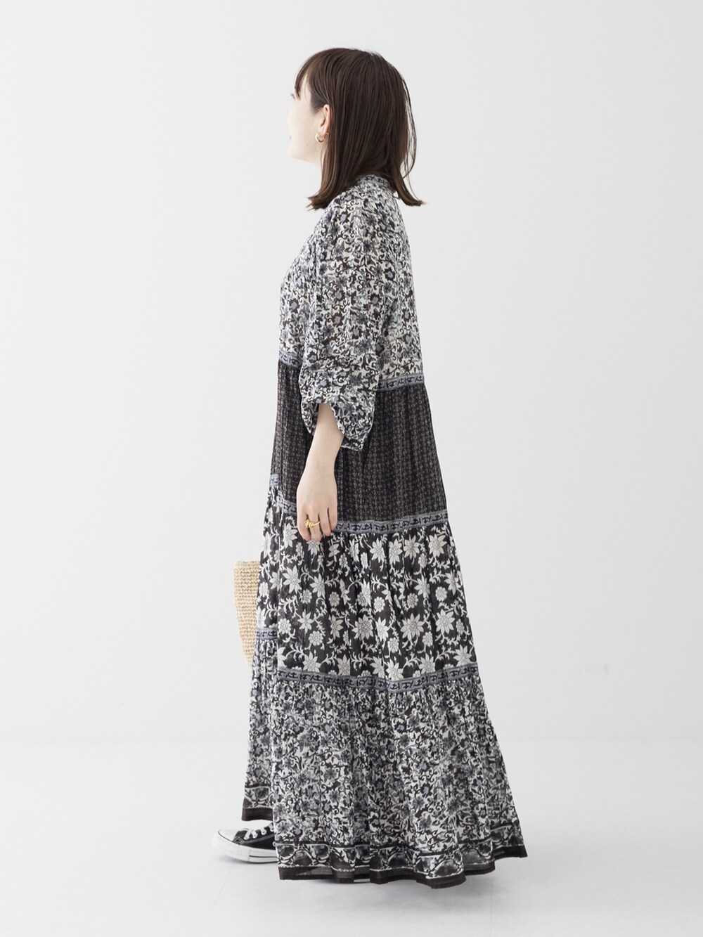 ベージュ系のショルダーバッグ、ブラック系のワンピース、ゴールド系のリングを着用したレディースの春コーディネートの3枚目の写真